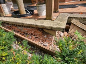 Water damaged masonry wall patio support