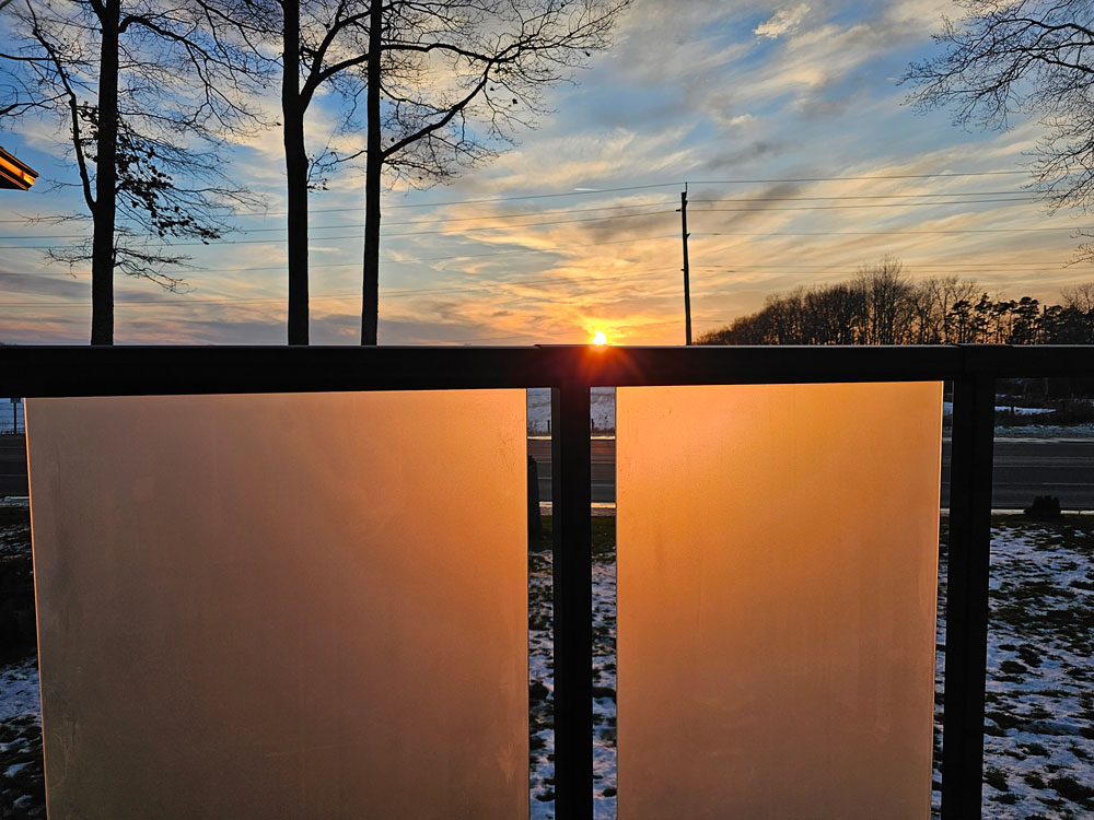frosted glass privacy wall at sunset